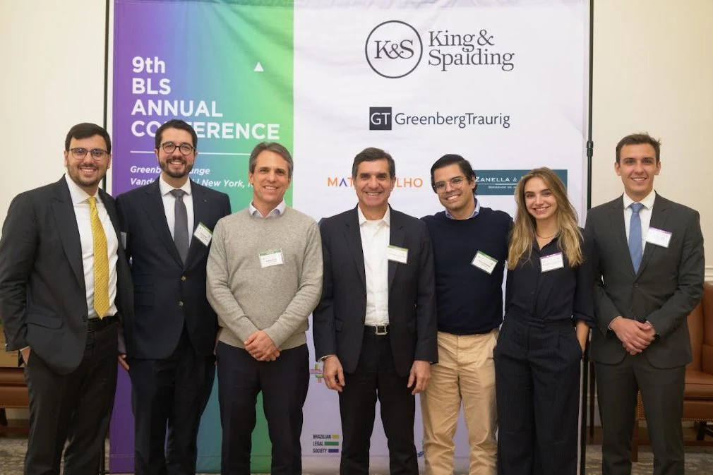 Speakers and BLS members at the 9th BLS Annual Conference, in front of the event backdrop