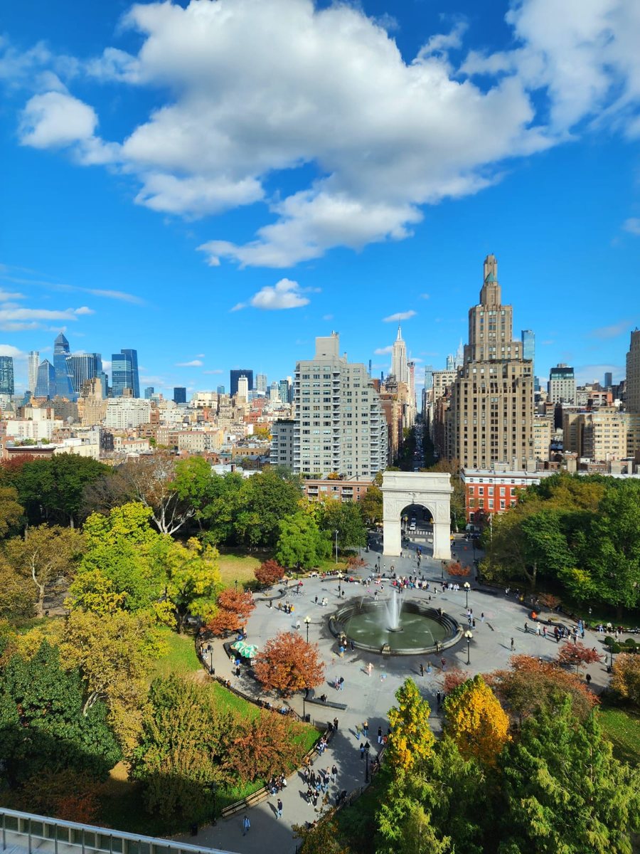 Washington Square Park in the fall, seen from above, with the arch, the fountain and the Manhattan skyline