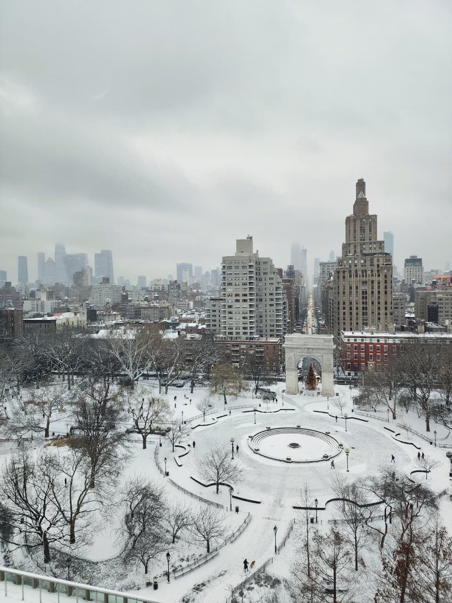 Washington Square Park covered in snow, seen from above, with the arch and a Christmas tree